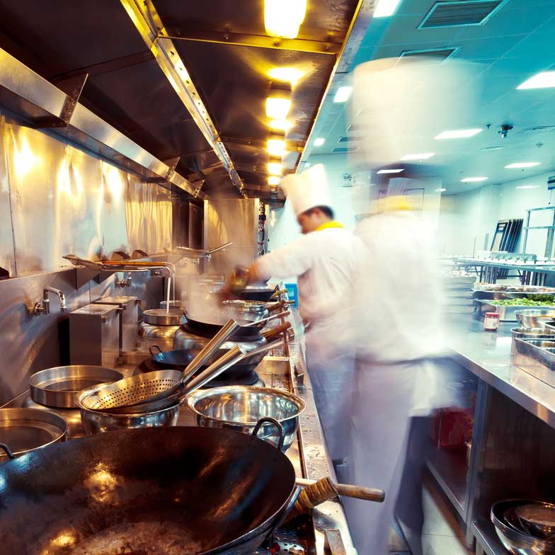 Chefs cooking in a busy kitchen