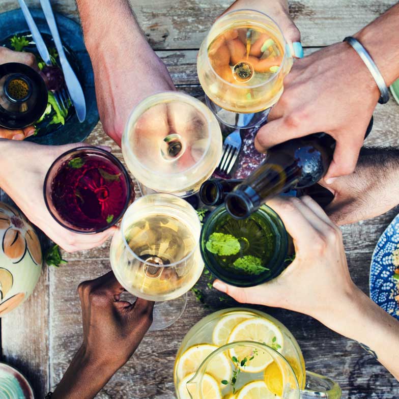 Group of friends giving a cheers at a table